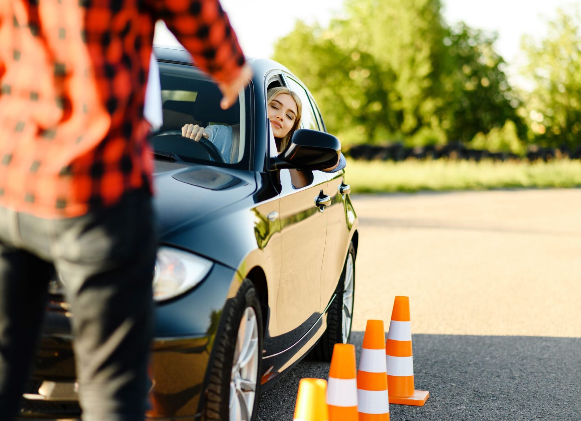 male-instructor-and-woman-in-car-traffic-cones-2026-01-06-09-15-49-utc